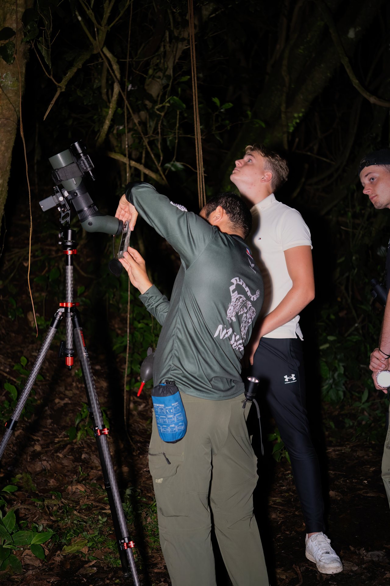 Night walk group with flashlights on a forest trail in the Monteverde Wildlife Refuge